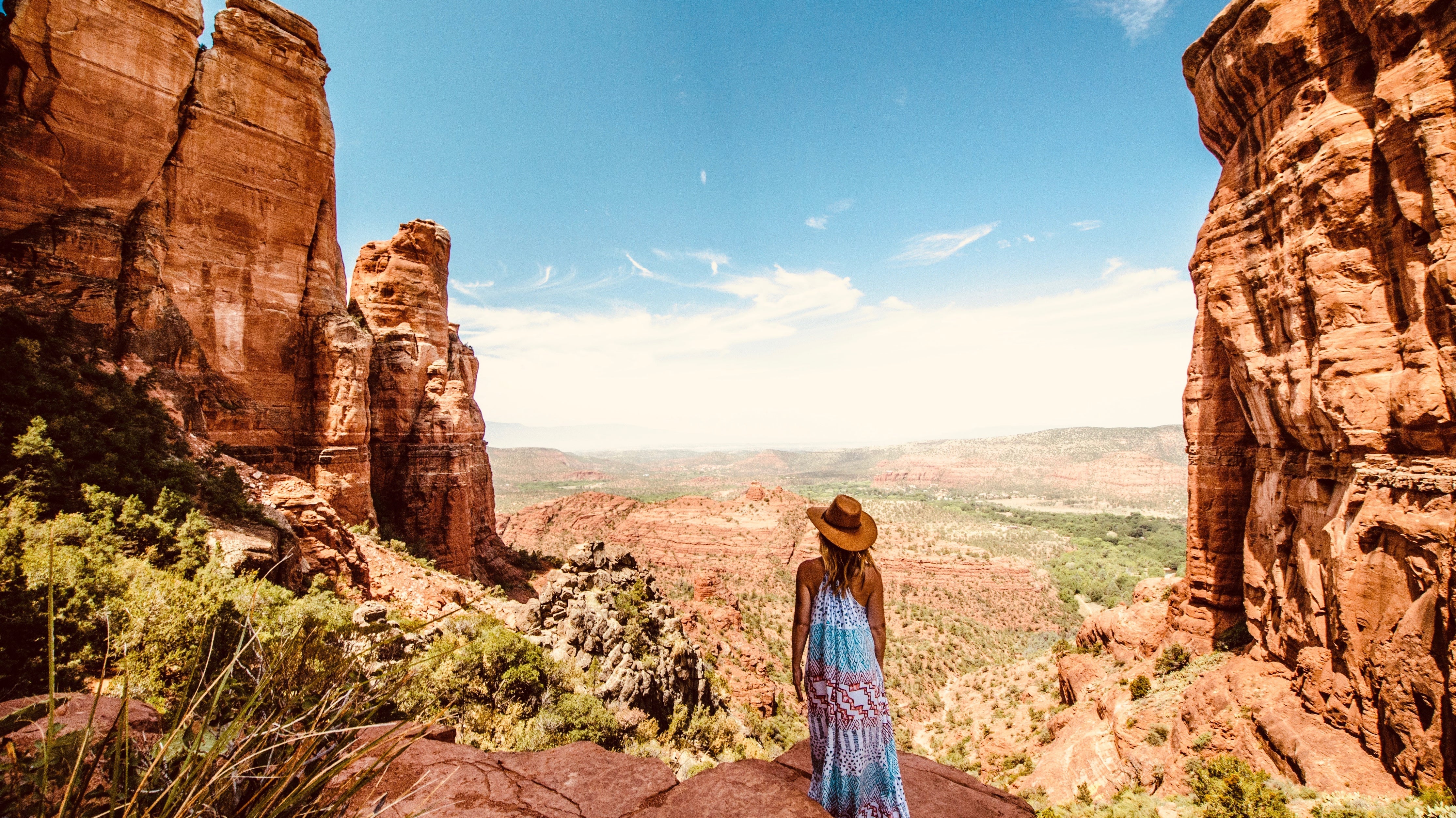 Woman wearing a dress and hat in a canyon