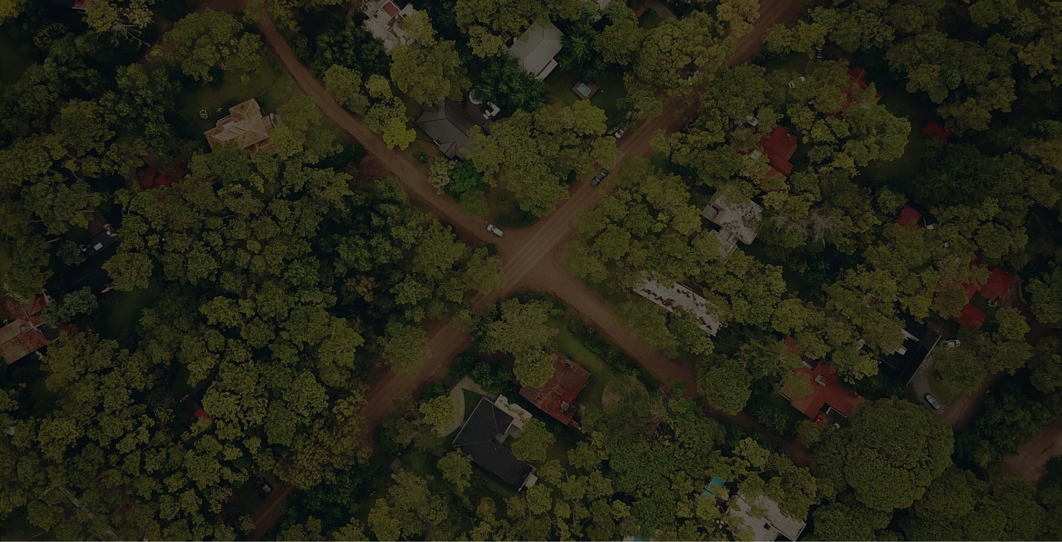 Image of a green landscape with brown roads running through.